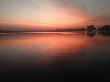 Scenic view of lake against romantic sky at sunset