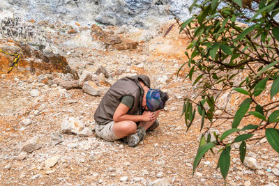 Woman sitting on rock