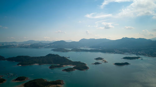 Scenic view of sea and mountains against sky