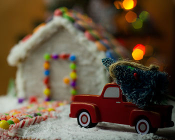 Close-up of gingerbread house with christmas decorations at home