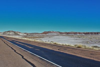 High angle view of empty road in dessert during sunny day