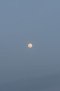 Low angle view of moon against clear sky at night