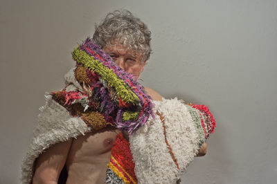 Portrait of woman with arms raised standing in snow