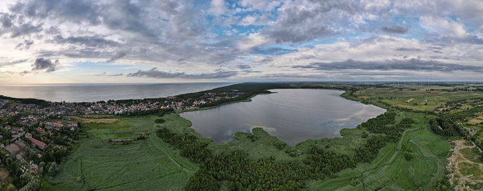 High angle view of sea and cityscape against sky