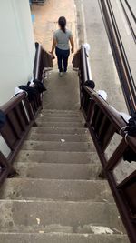 Rear view of woman walking on stairs