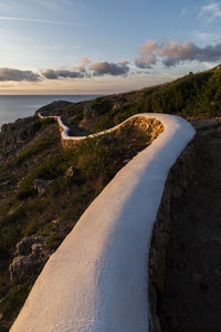 Aerial view of road by sea against sky