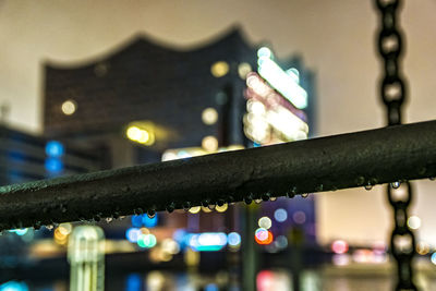 Low angle view of illuminated cityscape against sky at night