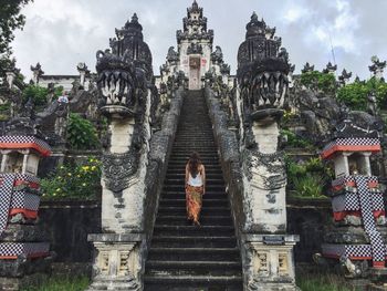 Rear view of a woman walking up stairs