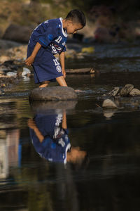 Boy standing in water