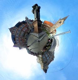 Digital composite image of clock tower against blue sky