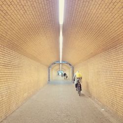 Person riding bicycle in tunnel 