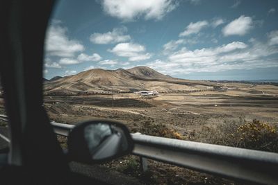 Scenic view of landscape seen through car windshield