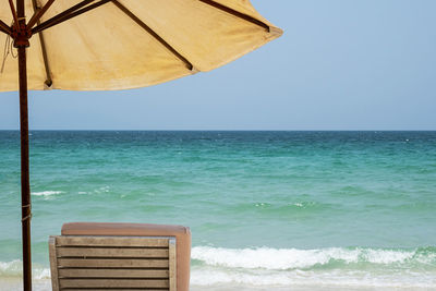 Sun lounger and beach umbrella against seascape. inspirational mood tropical resort.
