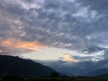 Scenic view of silhouette mountains against sky during sunset