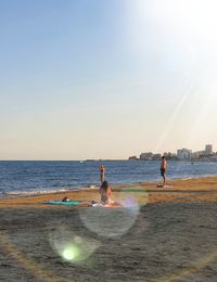 People on beach against sky