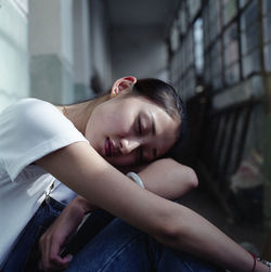 Tired woman napping in corridor