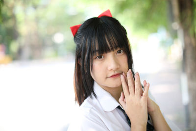 Portrait of young woman standing outdoors