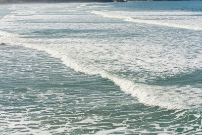 High angle view of waves rushing towards shore