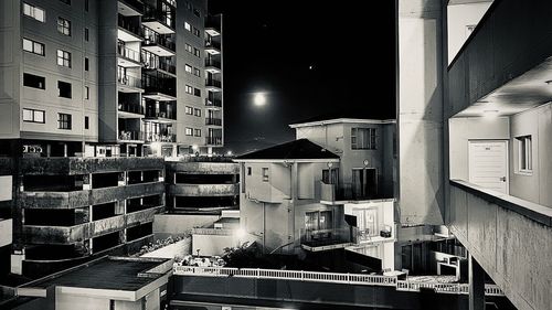 Buildings in city against sky at night