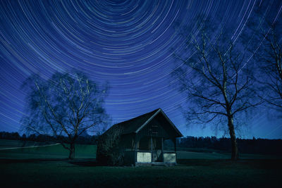 Built structure on field against sky at night