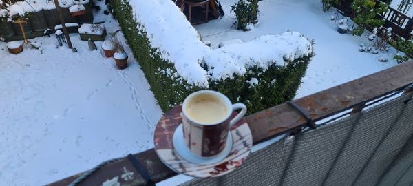 High angle view of coffee cup with ice cream
