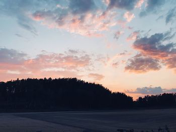 Scenic view of silhouette trees against sky during sunset