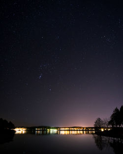 Scenic view of lake against sky at night