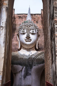 Statue of temple against building