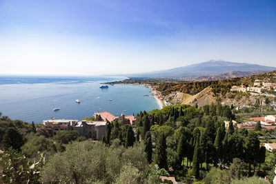 High angle view of houses by sea against clear sky
