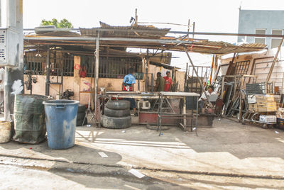 People working on street by building