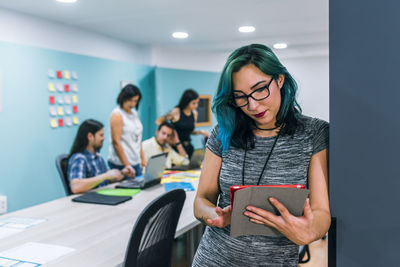 A business woman using a tablet in a coworking office