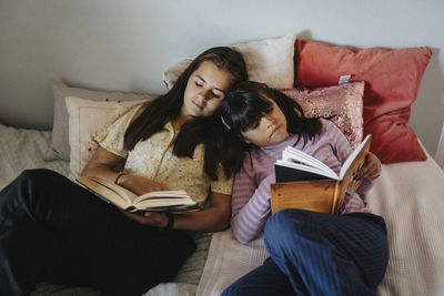 Sisters bonding over reading books together