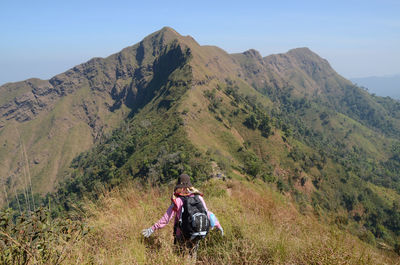 Rear view of woman hiking on mountain