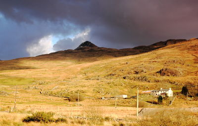 Scenic view of mountains against cloudy sky