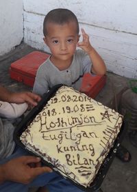 High angle view portrait of boy holding camera