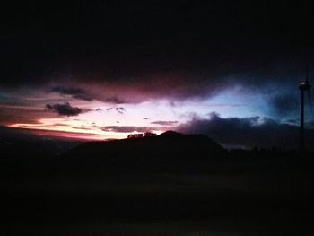 Scenic view of silhouette mountain against sky at night