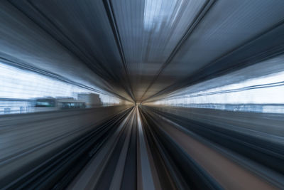 Blurred motion of train at railroad station