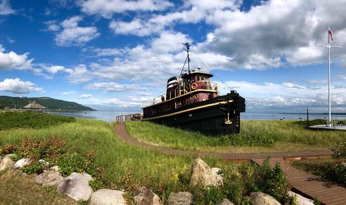 Abandoned ship in sea against sky