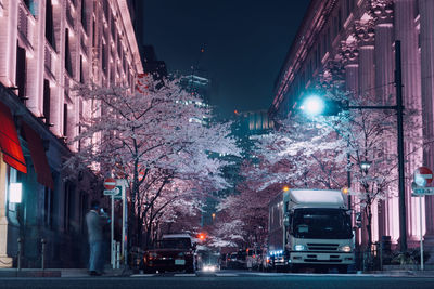 City street amidst buildings at night