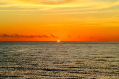 Scenic view of sea against romantic sky at sunset