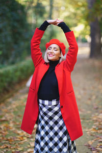 Portrait of young woman standing outdoors