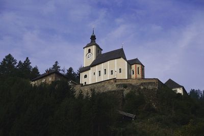 Low angle view of church against blue sky