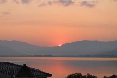 Scenic view of lake against romantic sky at sunset