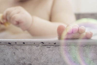 Low section of boy in bathtub