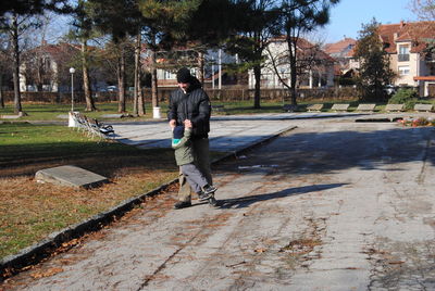 Full length of man on sidewalk in city