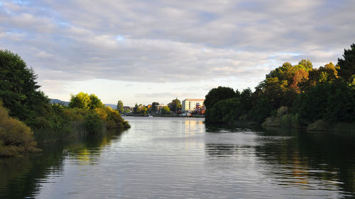 Scenic view of river against cloudy sky