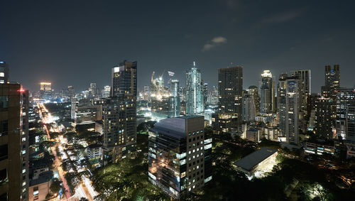 Aerial view of illuminated buildings in city at night