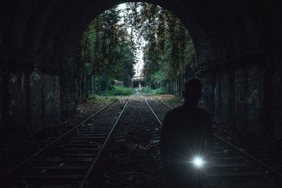 Rear view of man standing in tunnel