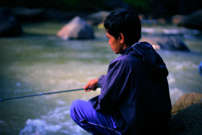 Side view of man playing outdoors