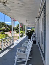 Empty chairs and tables in cafe amidst buildings